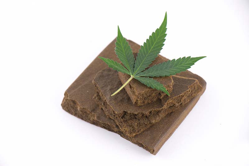 Small block of hash with cannabis leaf Small block of hash with cannabis leaf